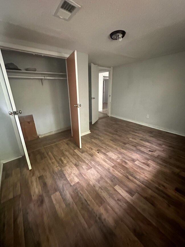 Unfurnished bedroom featuring wood-type flooring a