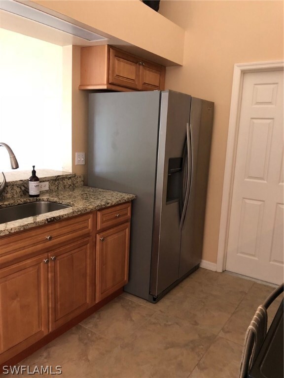 Side by side Fridge with water and ice dispenser on the door.