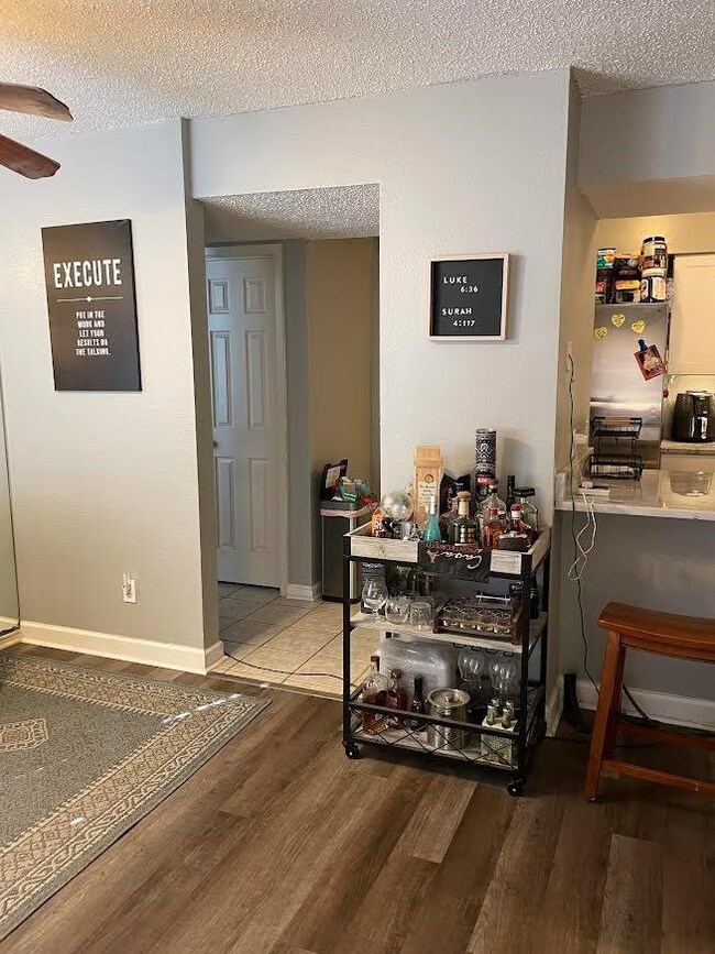 Corridor featuring wood finished floors, baseboard
