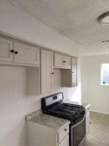 Kitchen featuring a textured ceiling and stainless