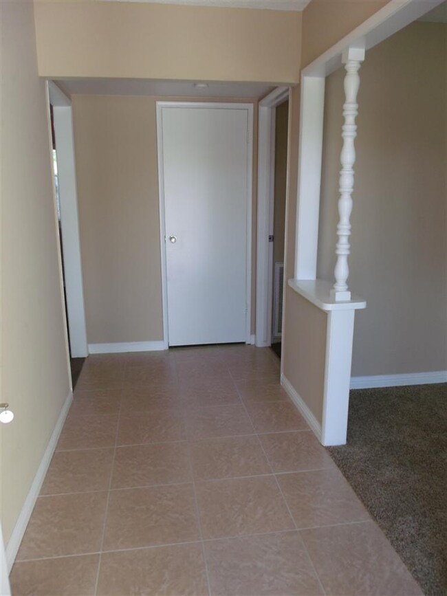 Open entry with stone look tile floors. Formal liv