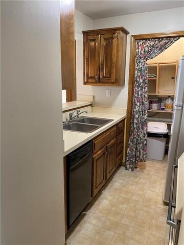 Second View of Kitchen Sink, Dishwasher, Cabinets,