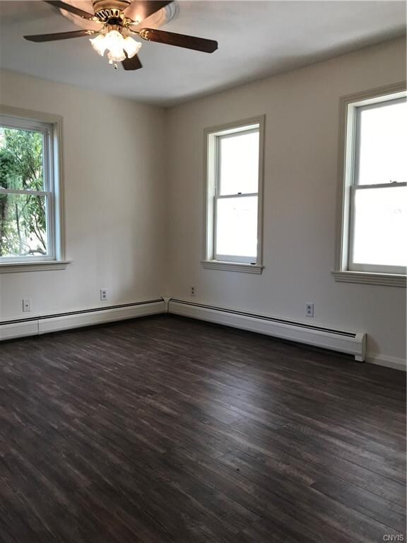 LIVING ROOM WITH PLENTY OF WINDOWS TO WARM THIS UP