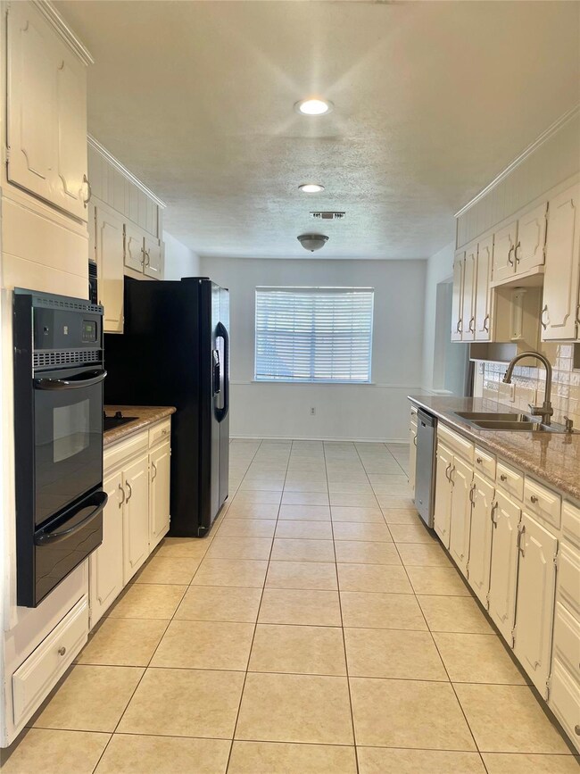 Kitchen featuring visible vents, a sink, a warming