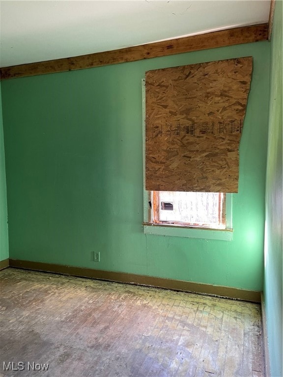 Empty room featuring baseboards