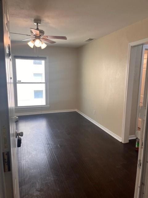 Spare room featuring ceiling fan and dark hardwood