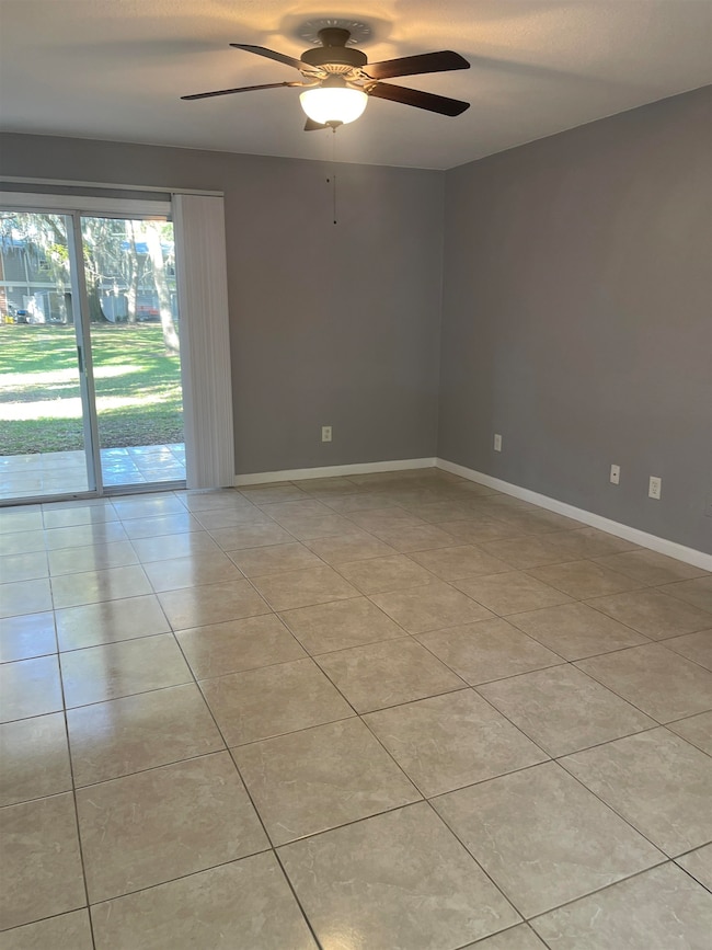 Spare room featuring light tile patterned floors and a ceiling fan