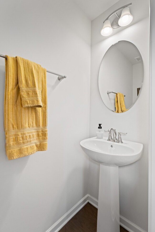 Family and friends don't need to enter the upstairs private space with this first-floor half bath. 