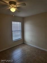Spare room with a ceiling fan and baseboards