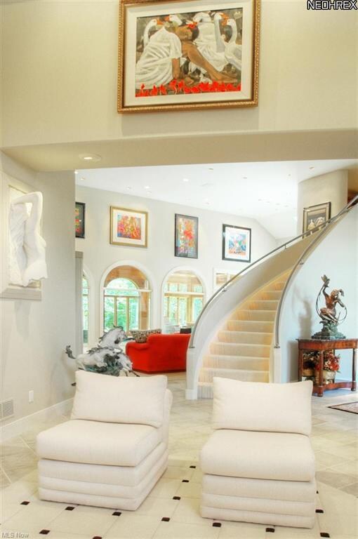 Curved staircase with accent lighting and brushed 