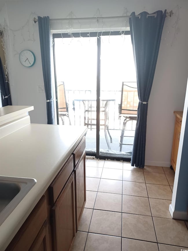 Kitchen featuring sink and light tile floors