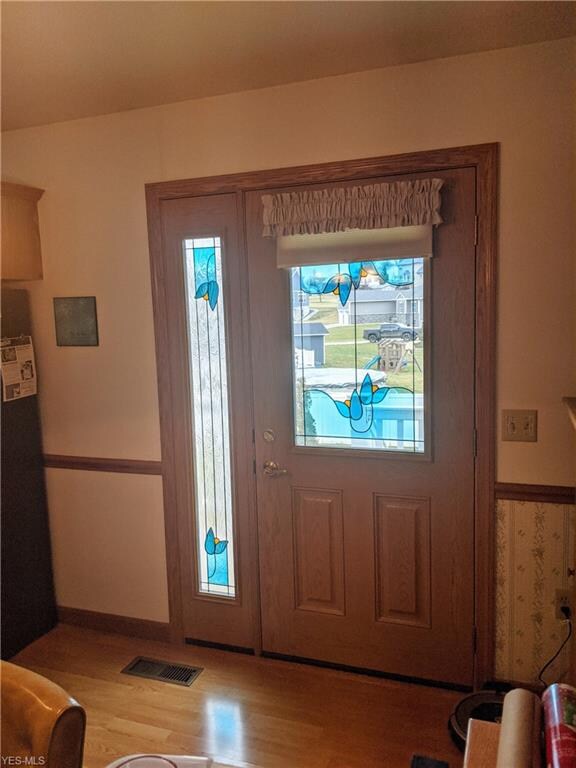 Custom stained glass door in kitchen leads to outd