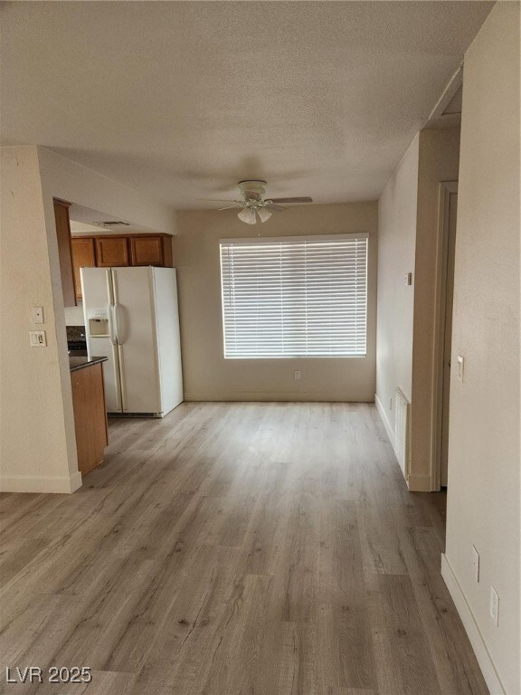 Unfurnished living room featuring light wood-style