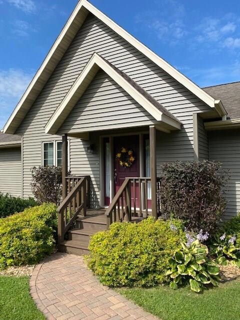 A beautiful paved walkway leads up to the inviting