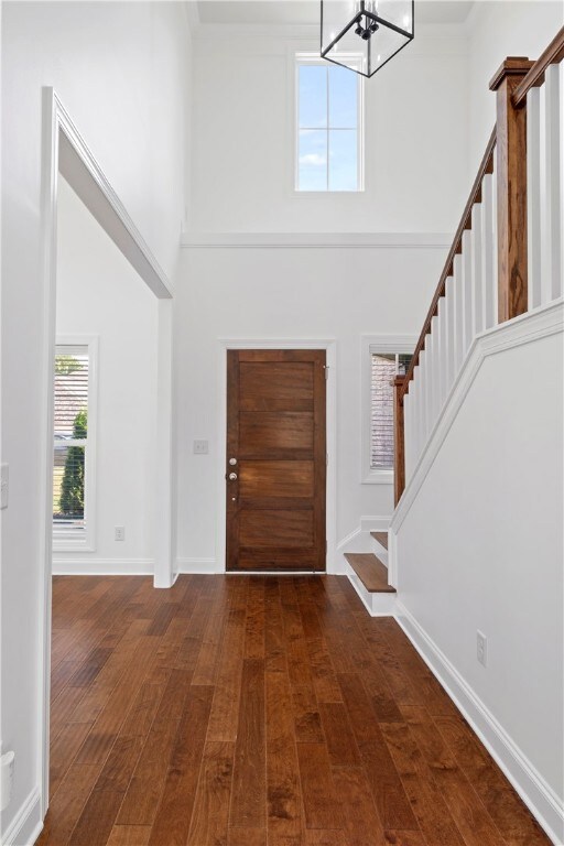 A two-story foyer opens to a lovely staircase to t