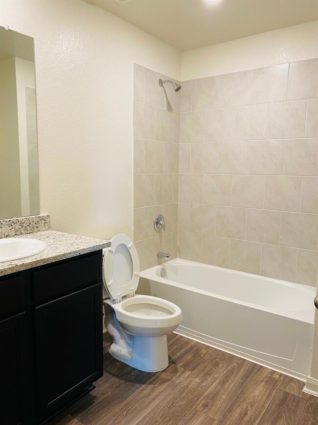 Full bathroom featuring wood finished floors, van