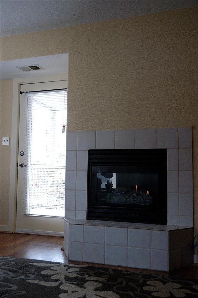 Fireplace and door leading to deck.