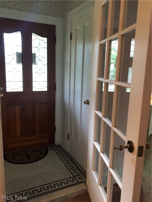 tiked foyer with double door entry