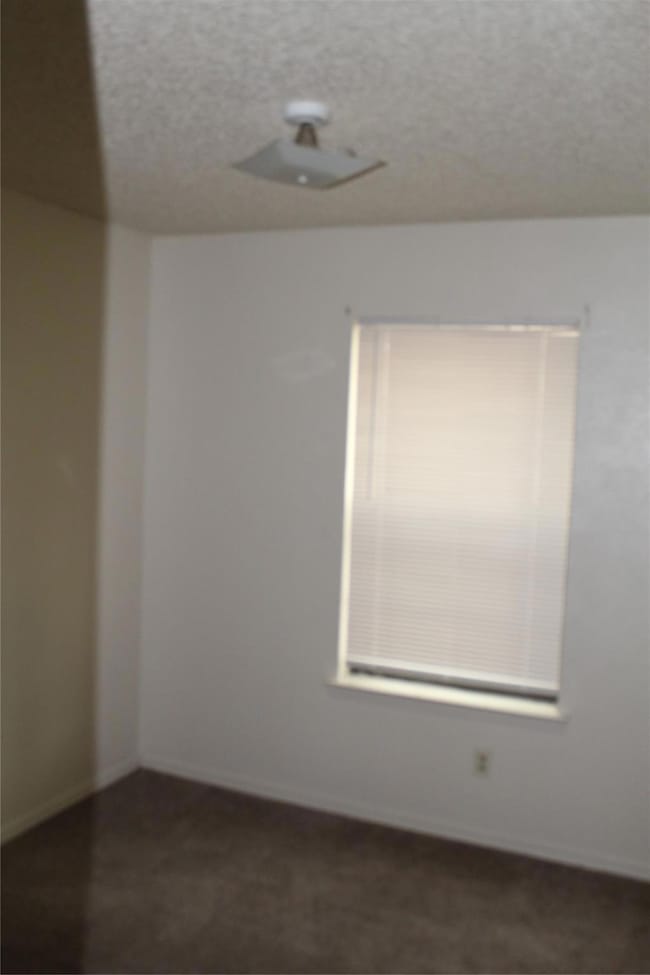 Empty room with a textured ceiling