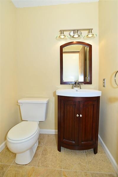 The half bath has been updated with a granite tile