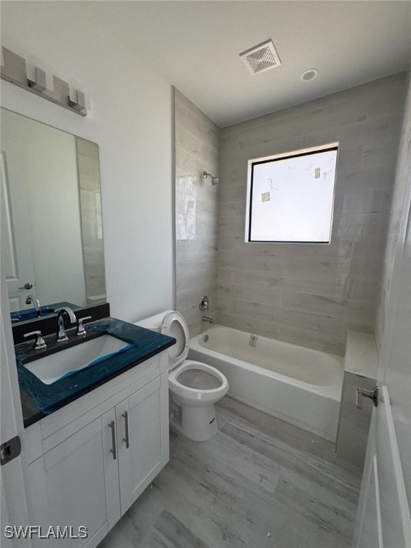 Full guest bath with wood plank finished floors, t