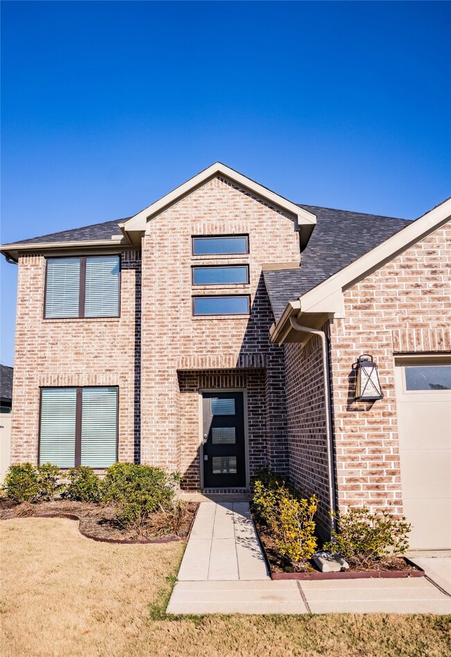 This photo showcases a modern two-story brick home