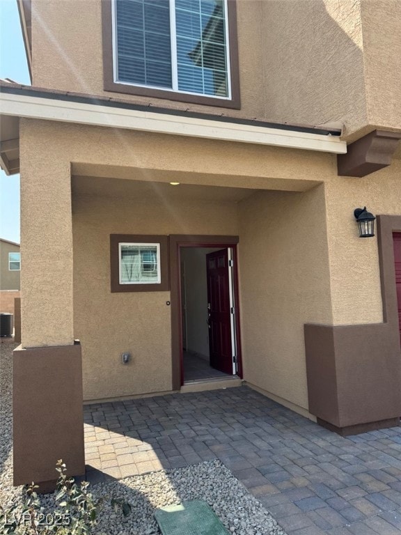 View of exterior entry featuring central AC unit,
