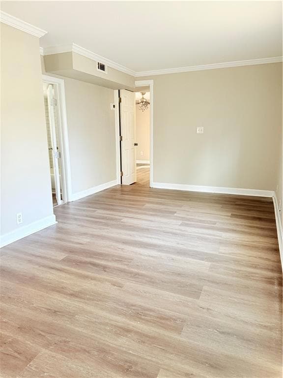 Unfurnished room featuring visible vents, crown mo