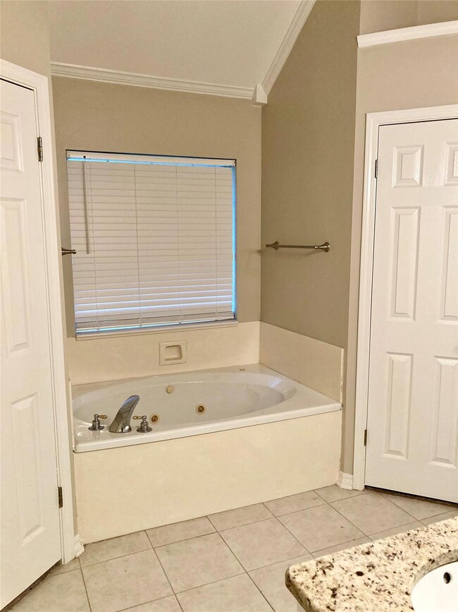 Bathroom Primary with ornamental molding, tile pat