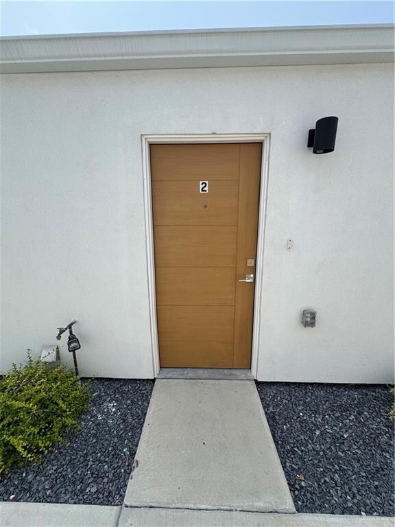 View of exterior entry featuring stucco siding