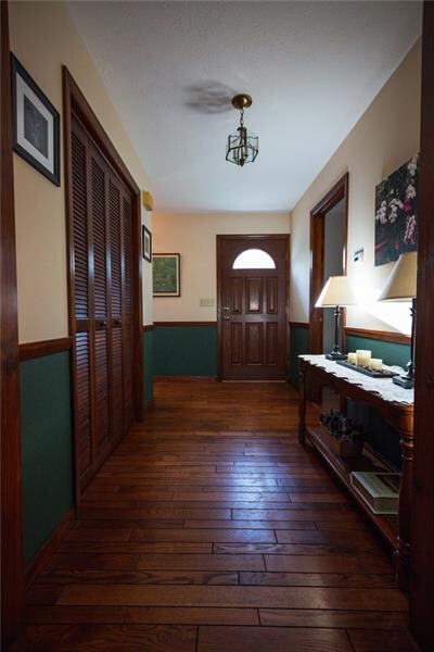 Random plank hardwood floors grace the foyer.  Har