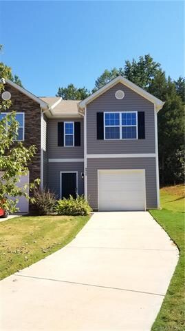 Long tandem driveway leads to a one car garage. Ni
