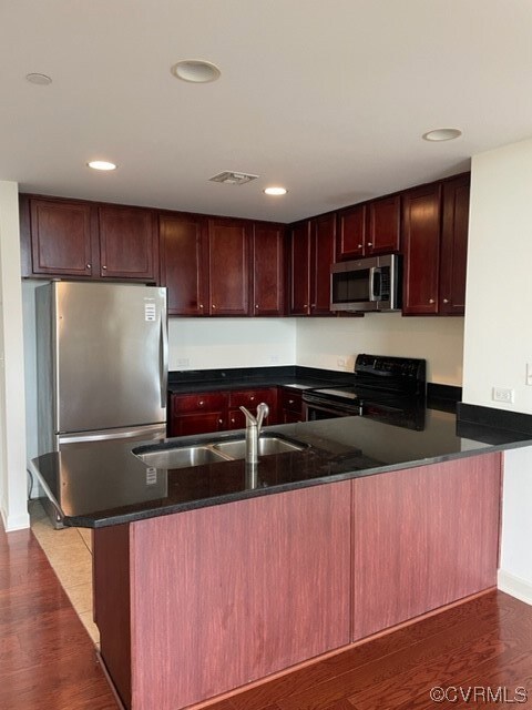 Kitchen featuring sink, range, dark stone counters