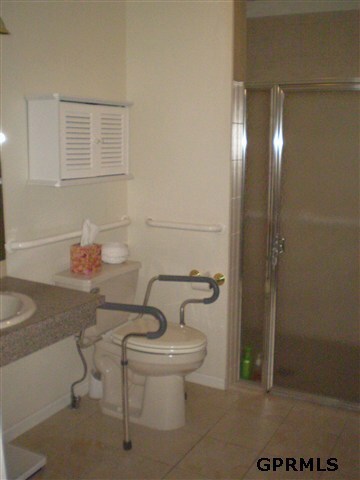 master suite bath has safety features and extra large shower that is wheelchair friendly.