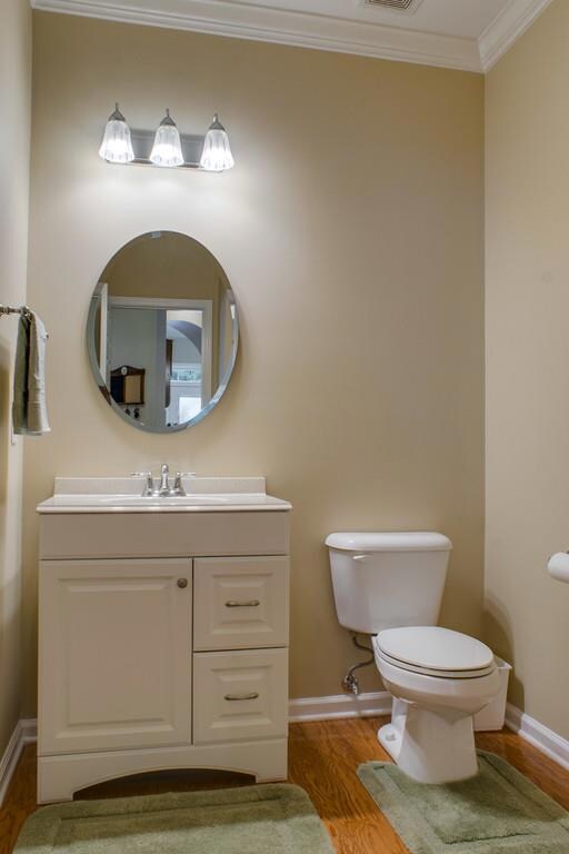 Remodeled 1/2 bath offering new fixtures and tile floors.