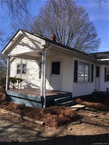 Cute side porch shows new landscaping.