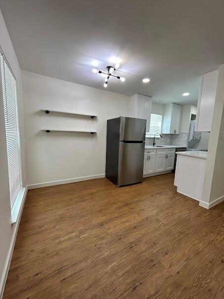 Kitchen with freestanding refrigerator, dark wood