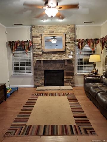 Cozy living room with stone fireplace that has gas