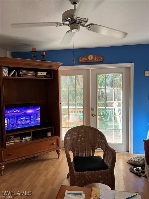 Living room with wood finished floors, ceiling fan