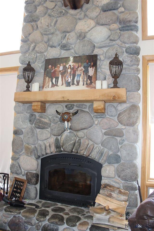 beautiful floor to ceiling wood-burning stone fire