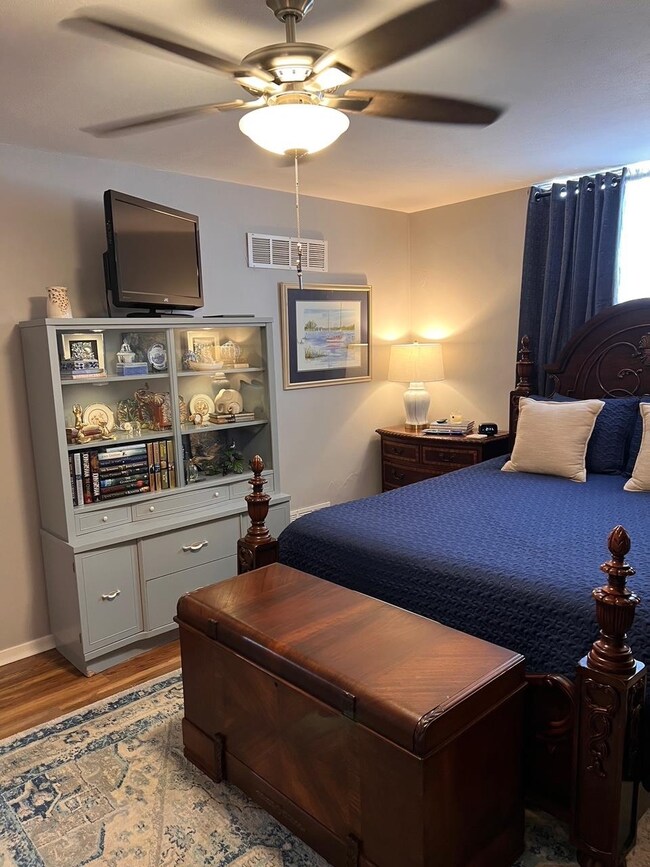Bedroom with light hardwood / wood-style flooring 