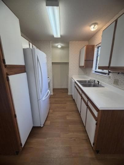 Kitchen featuring freestanding refrigerator, ligh