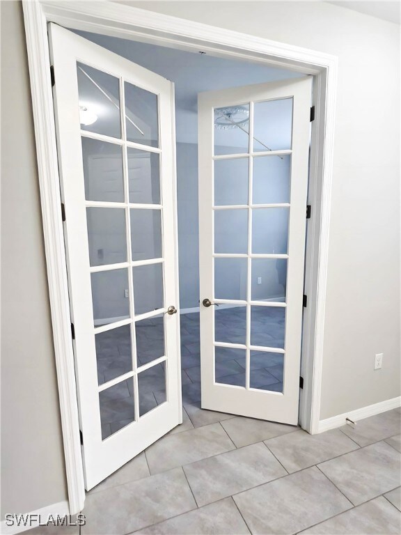 Entryway featuring french doors, tile patterned fl