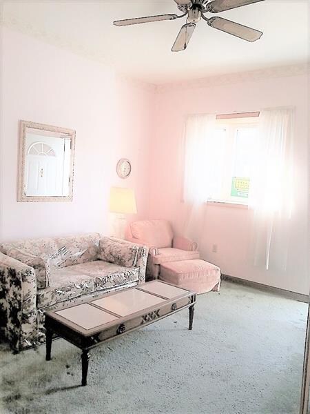 Living room with wood flooring under the carpets.