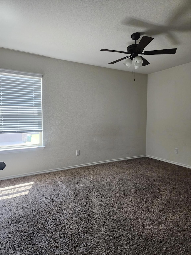 Spare room with carpet floors, a textured ceiling,
