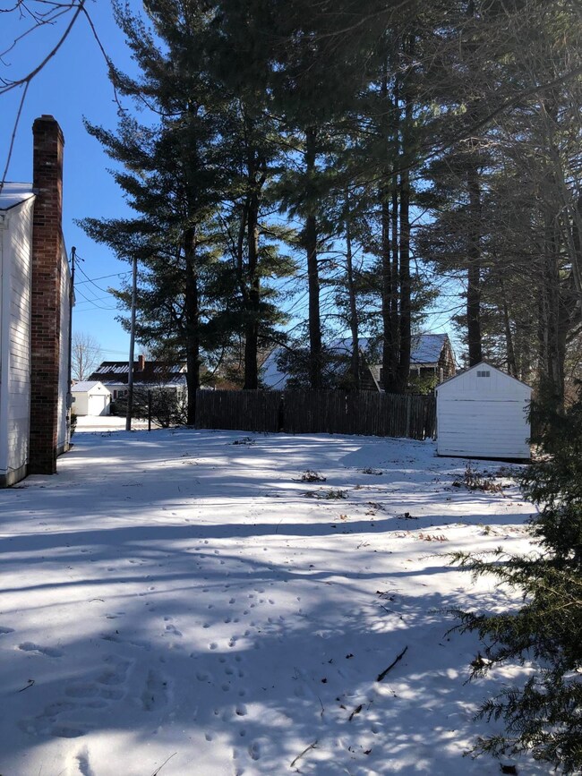 Yard to the left of the house with shed