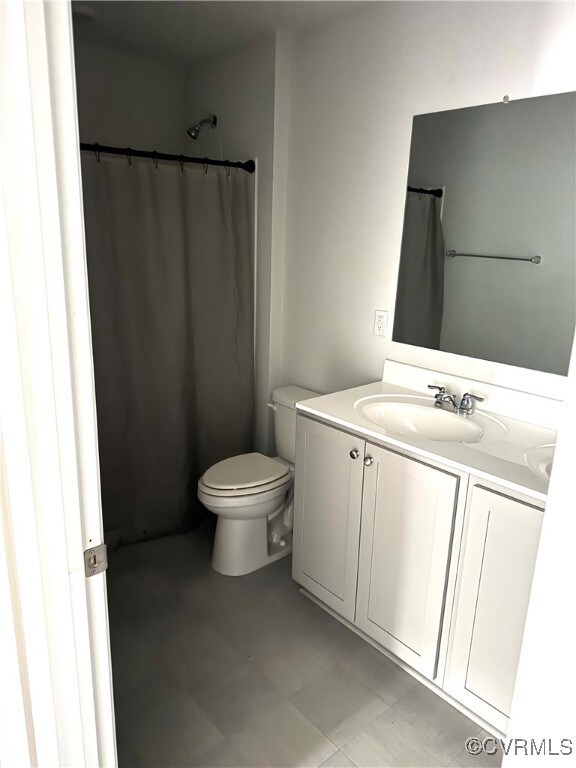 Full bath featuring vanity, tile patterned floors,