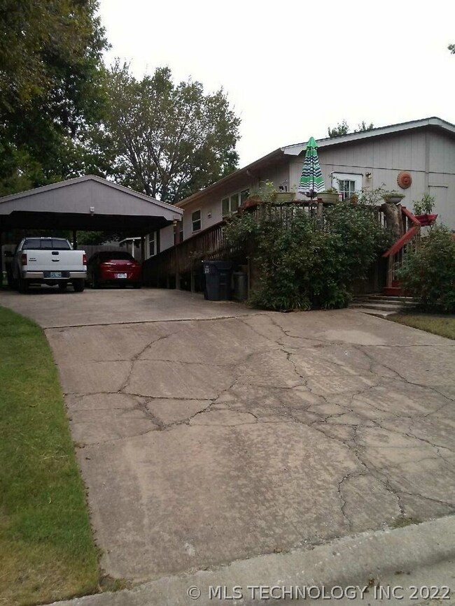 West side of home, driveway and carport