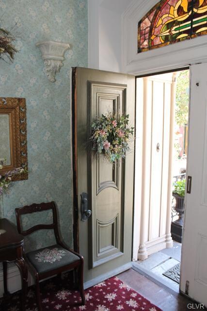 View of the welcoming front entrance with stained 