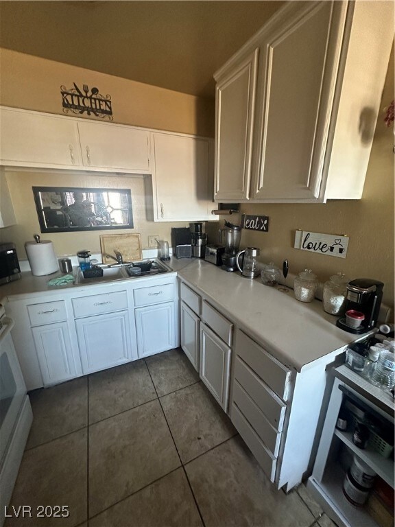 Unit A: Kitchen featuring white cabinetry, light c